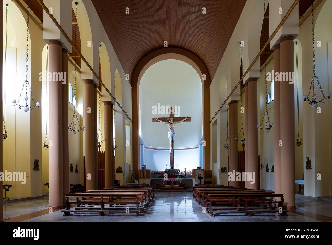 Timau, Italy (21st July 2023) - Inside view of the Cristo Re (King Christ) church with the imposing wooden crucifix that is 12 meters high Stock Photo