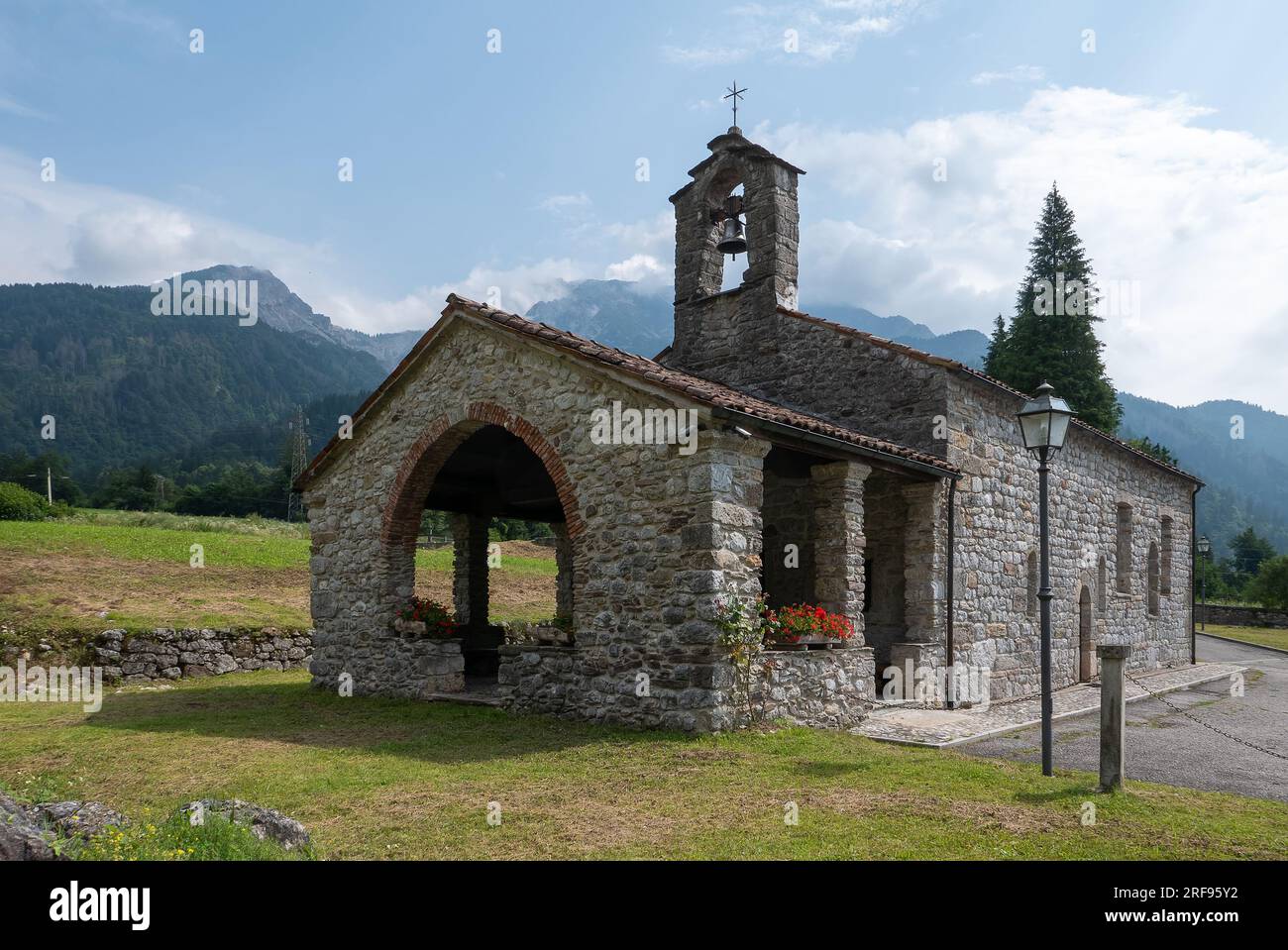 Arta Terme, Italy (26th July 2023) - The antique church of San Nicolò degli Alzeri (St. Nicholas) dated to 13th-14the century Stock Photo