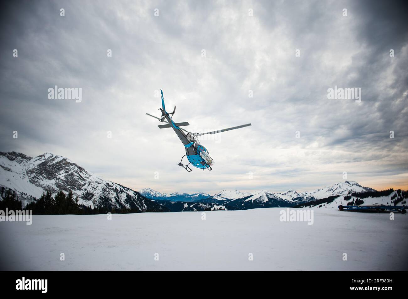 The trackers ensure the safety of the slopes for the skiers, a helicopter evacuates an injured person. Stock Photo