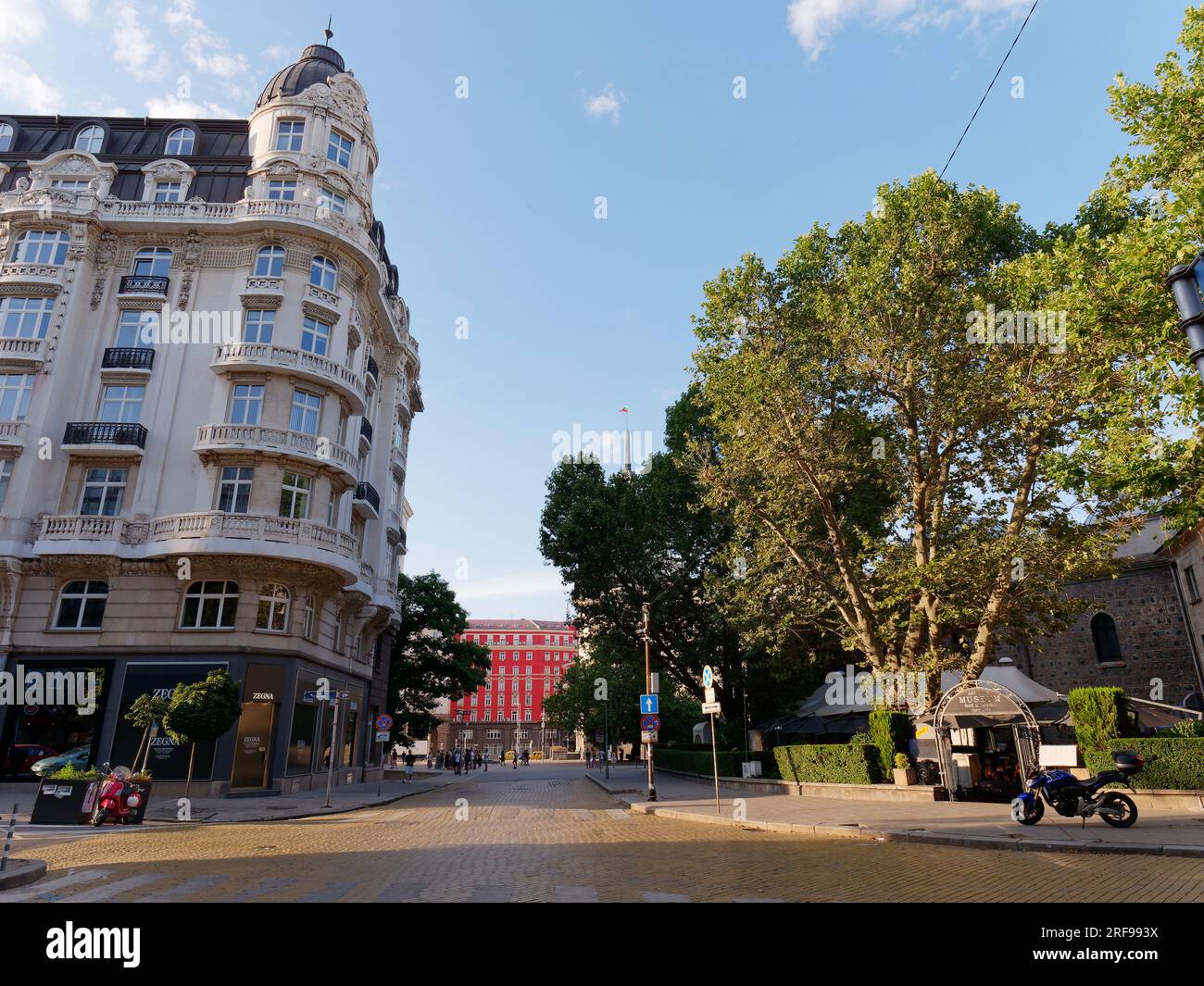 Street in the City of Sofia with elegant multi storey building left and red building behind, Bulgaria. August 1, 2023. Stock Photo