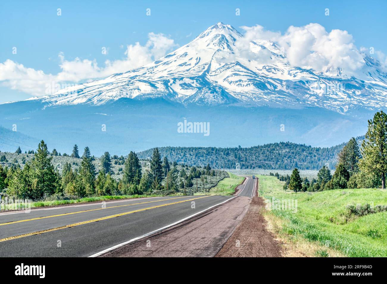 Long road leading towards Mt Shasta in the Cascade mountains in the Klamath National Forest of California Stock Photo