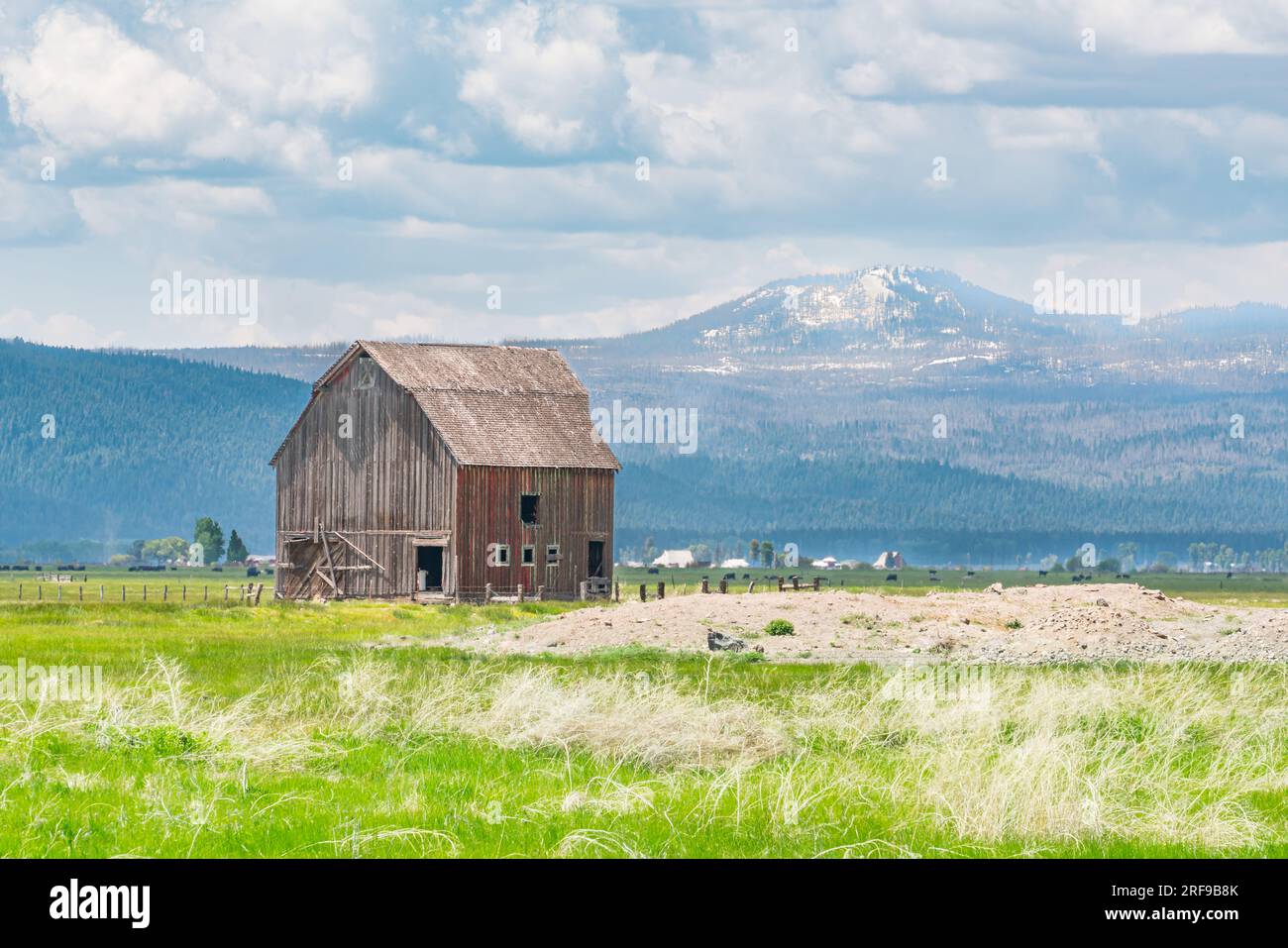 Old wooden barn in farm field of the Cascade Mountains of Oregon Stock Photo