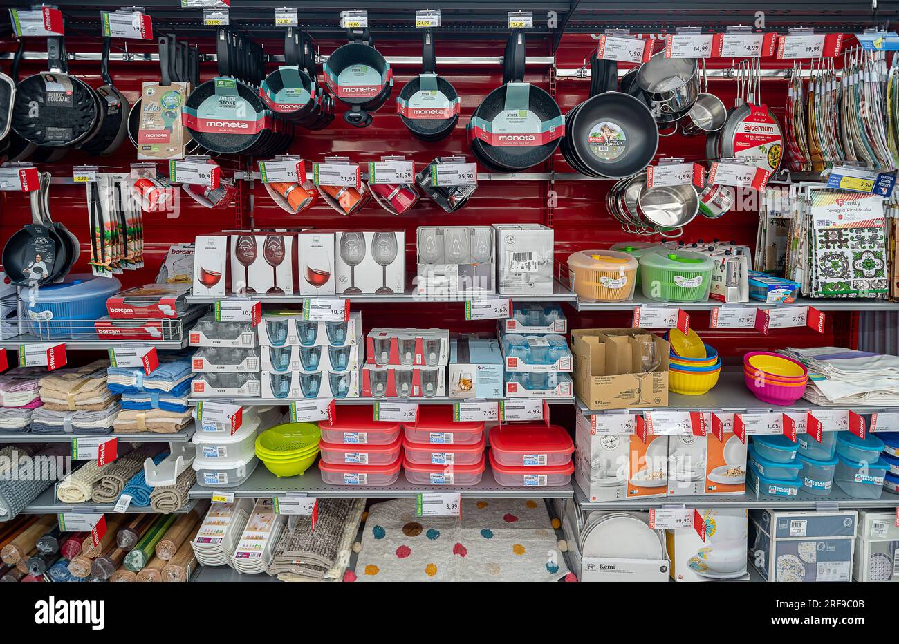 Italy - July 29, 2023: Kitchen accessories, pots, coffee pots and glasses and plastic box displayed on the shelf of an Italian supermarket Stock Photo