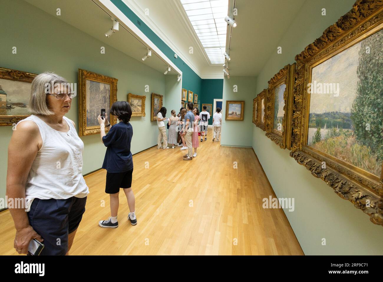 Visitors looking at paintings in the interior of the Rouen museum of Fine Arts - Musee des Beaux Arts, Rouen France Europe Stock Photo