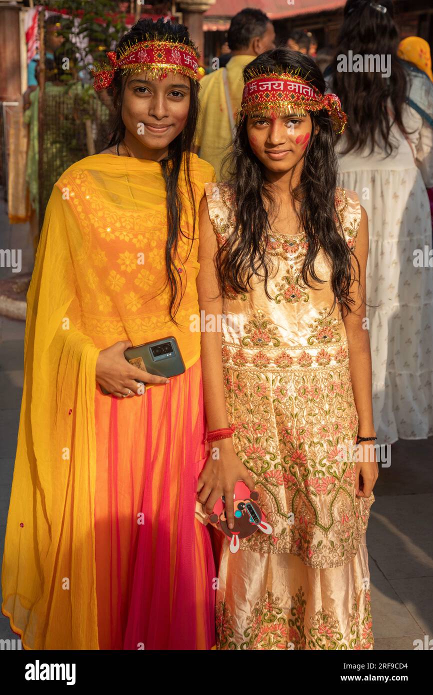 Two young Hindu women, dressed in their finest during a pilgrimage to the Kamakhya Temple, Guwahati, Assam, India. Stock Photo