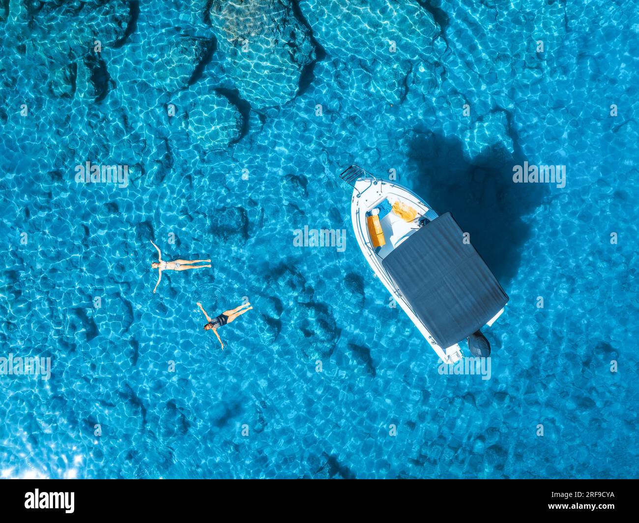 Aerial view of small motorboat and swimming people in the sea Stock ...