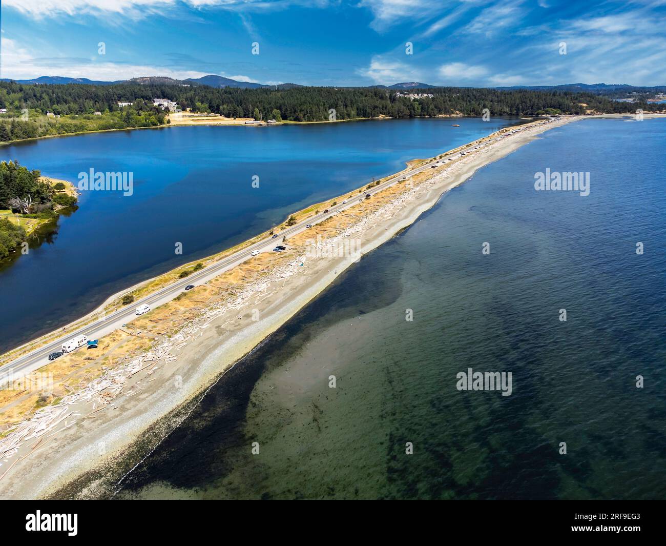Aerial Esquimalt Lagoon sand spit overlooking Royal Roads University with a long straight road in Victoria British Columbia Canada. Stock Photo