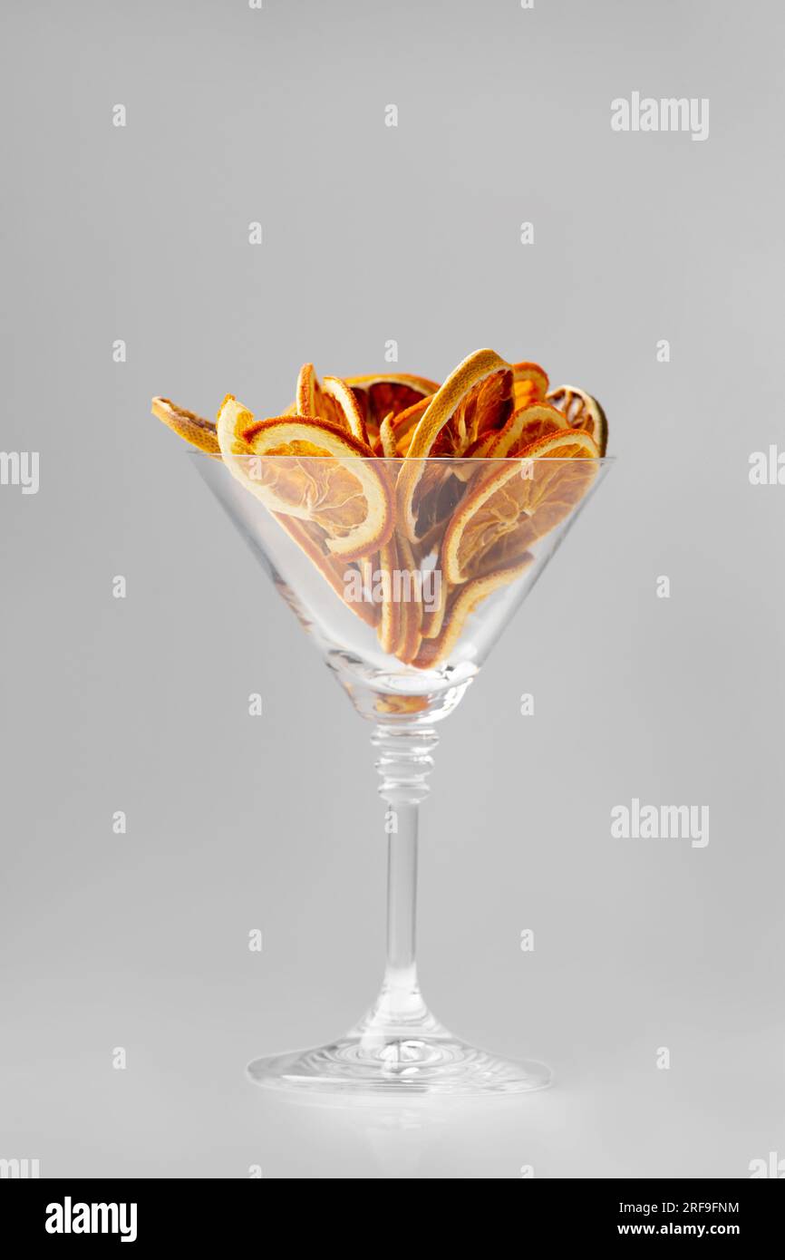 Dry orange chips isolated. Orange chips in a martini glass on a white