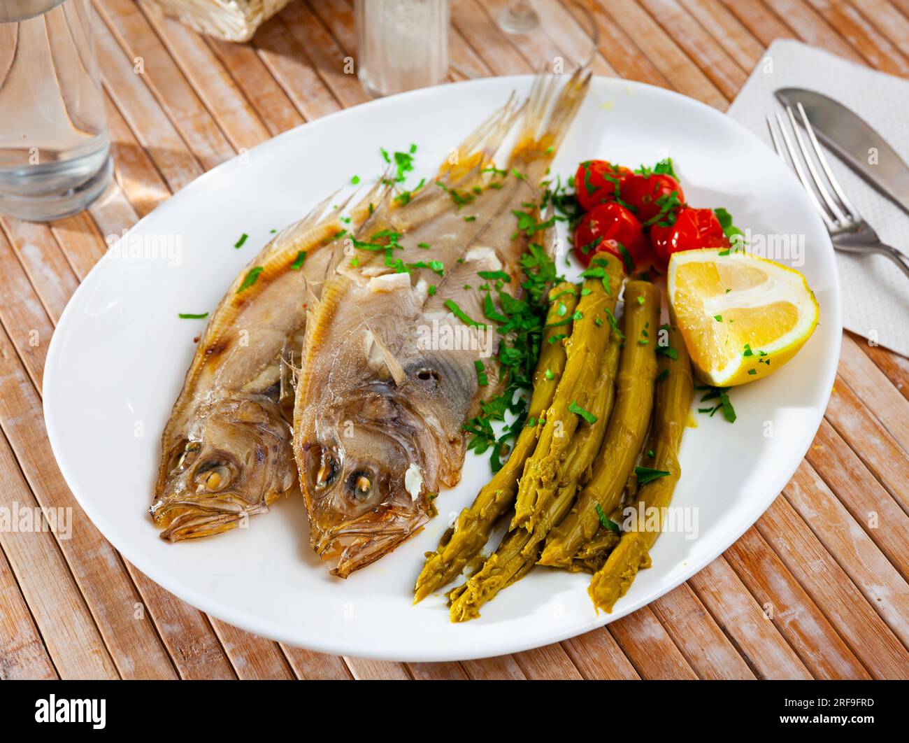 Oven baked rooster fish with marinated asparagus Stock Photo Alamy