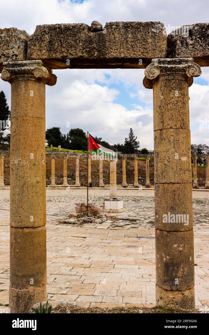 Jerash, Jordan : The ancient columns of Jerash, which were built by the Romans in the Middle Ages AND Jordanian flag Stock Photo