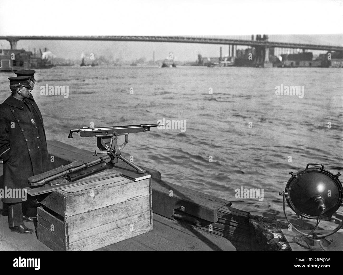 New York, New York:  c. 1921 New York City police and their harbor patrol boat keep on the watch for alcohol smugglers and rumrunners during Prohibition. Stock Photo