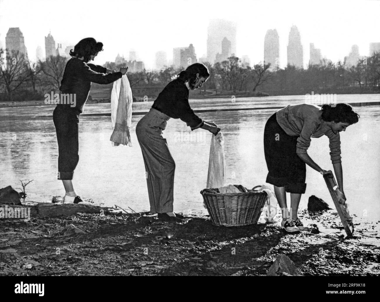 New York, New York:  1949 A water shortage in New York has these three young women washing their clothes at one of the lakes in Cantral Park. Stock Photo