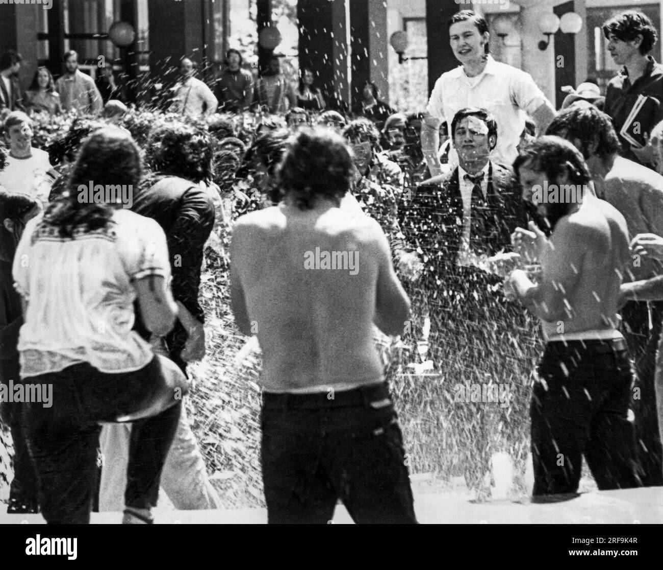 Berkeley, California:  May, 1969 People's Park demonstrators try and wash pepper spray from their eyes at a fountain after confrontations with the police. Stock Photo