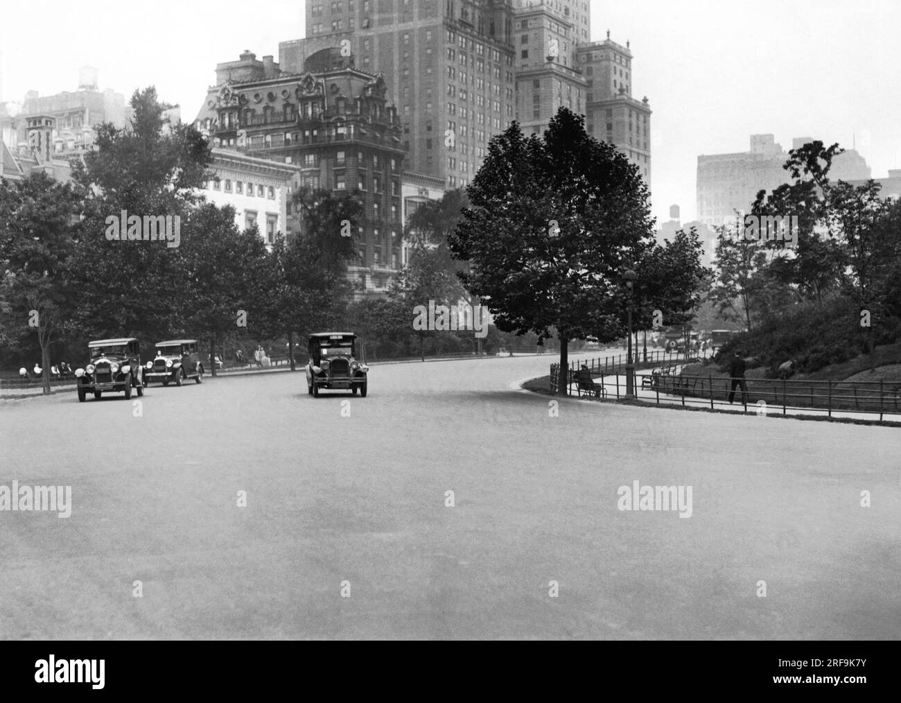 New York  New York:   c. 1928 Skirting Manhattan's famed Central Park, 59th Street opens into a wide boulevard.  The Essex Hotel is shown in the background with Hampshire House in front. Stock Photo