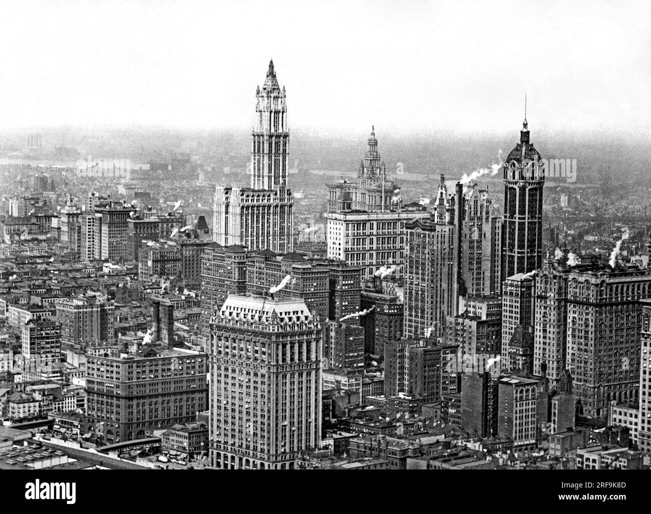 New York, New York:  c. 1915 The Financial District in New York City, with the Singer Building and its rounded  top at the right, and the Woolworth Building in the center. Stock Photo