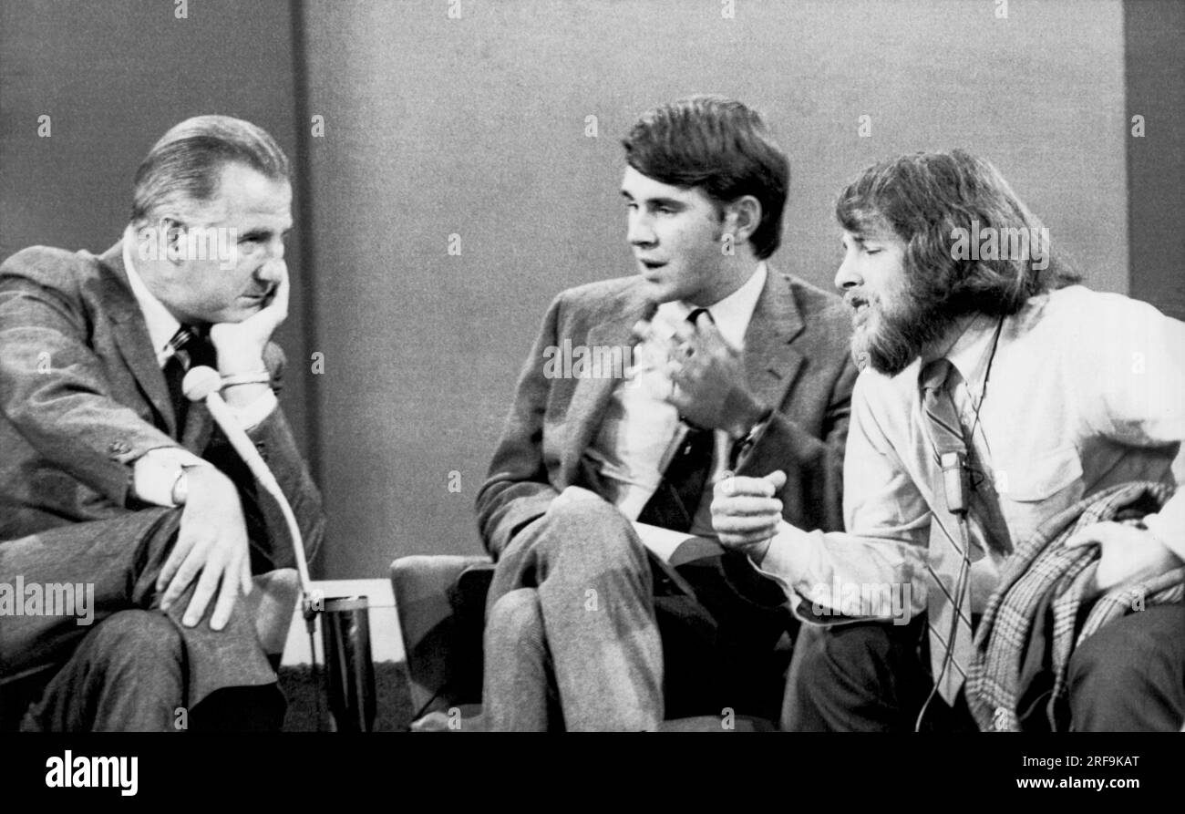 New York, New York:  September 21, 1970 Vice President Spiro T. Agnew listens as a University of Washington student Richard Silverstein (R) makes a point as Yale Law School student Gregory Craig looks on. The 90 minute debate was broadcast on the David Frost Show. Stock Photo