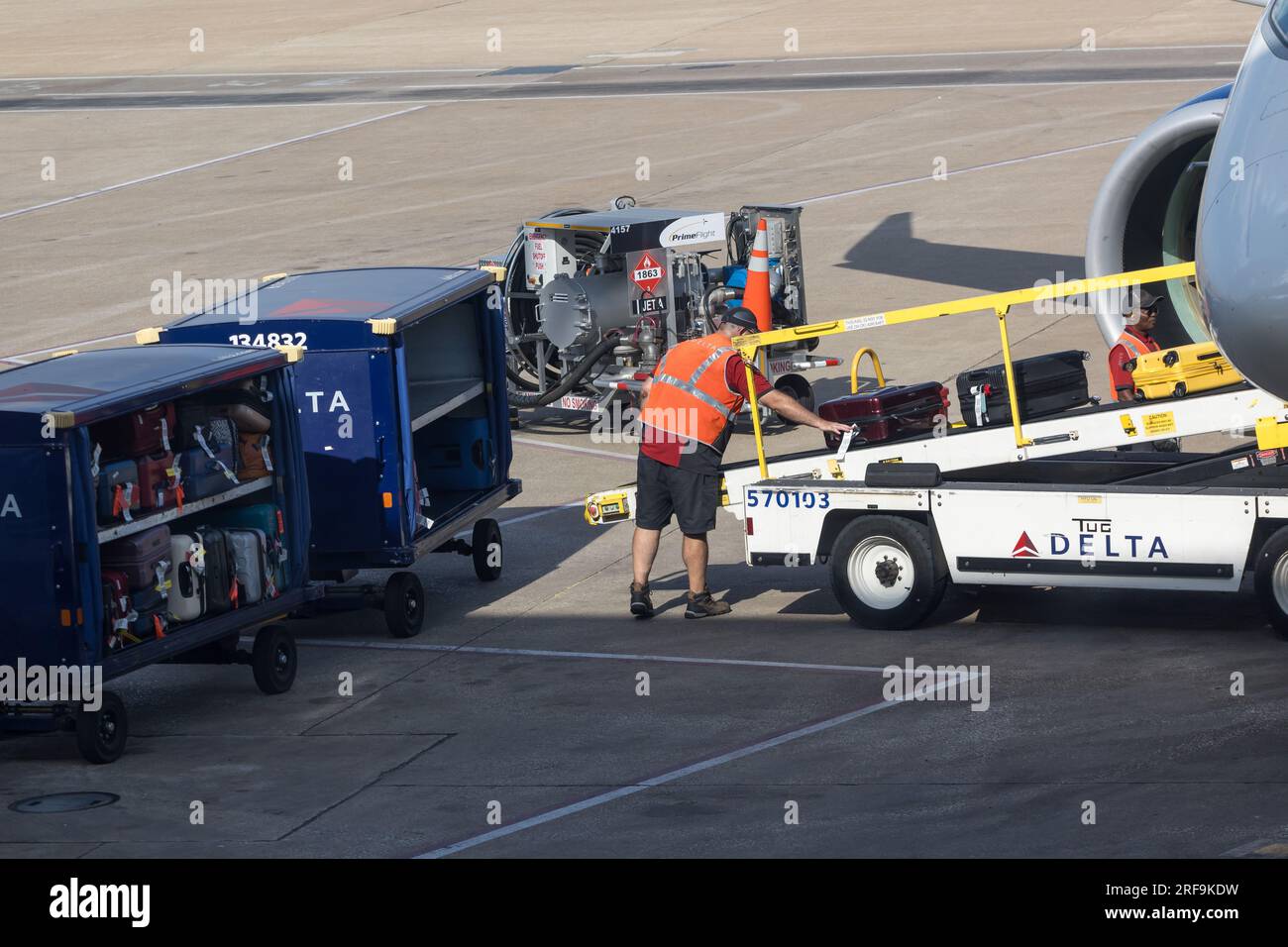 Men working to claim baggage for an airplane are seen at the Dallas