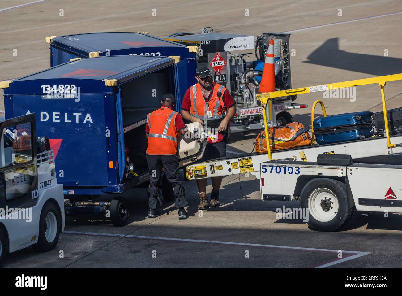 Men working to claim baggage for an airplane are seen at the Dallas