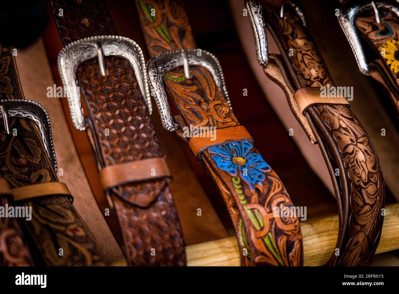 Cowboy boots and leather belts in a business showcase in the center of