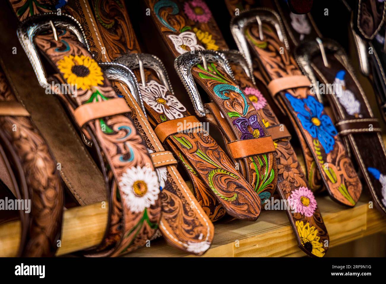 Cowboy boots and leather belts in a business showcase in the center of