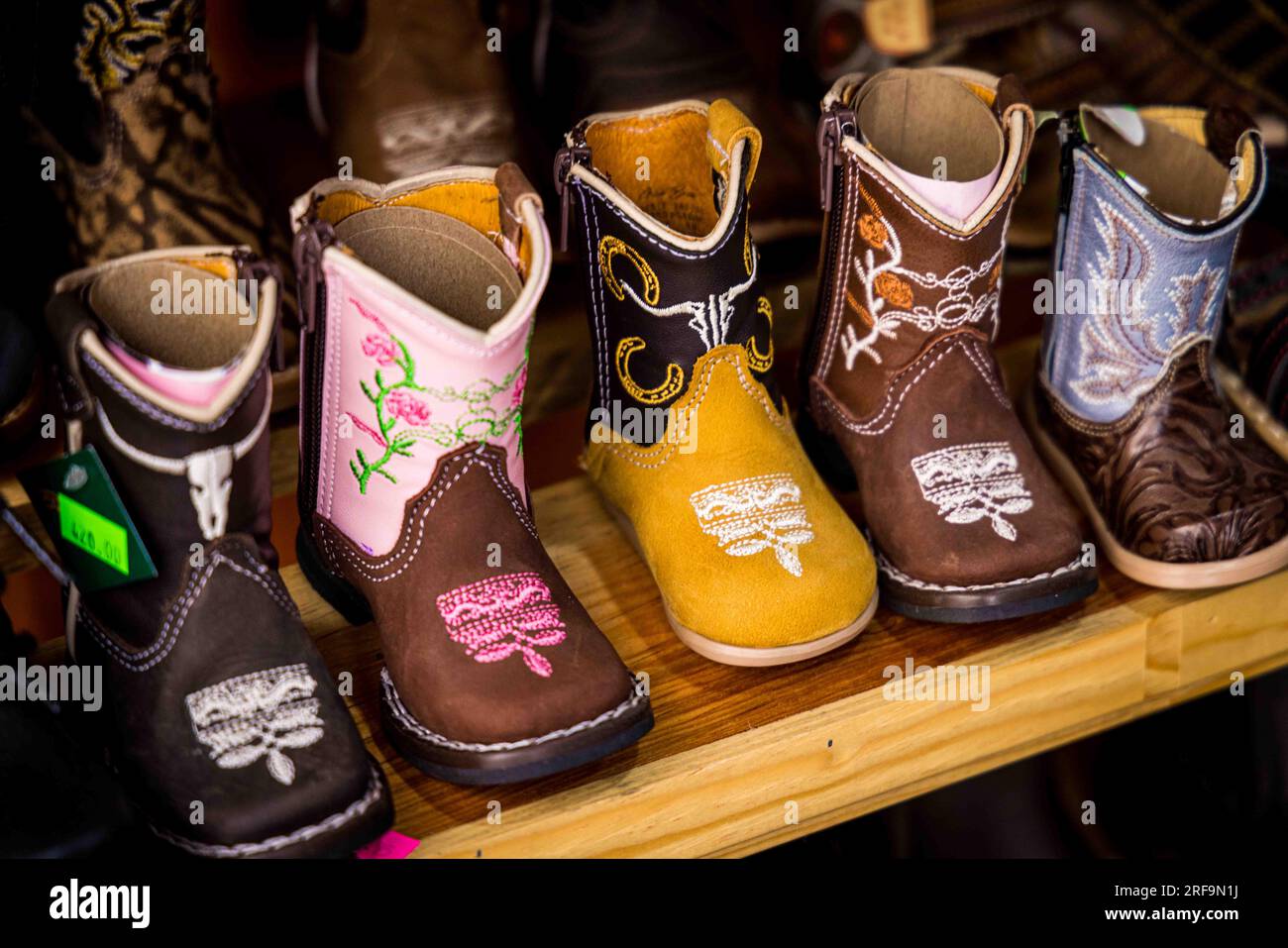 Cowboy boots and leather belts in a business showcase in the center of