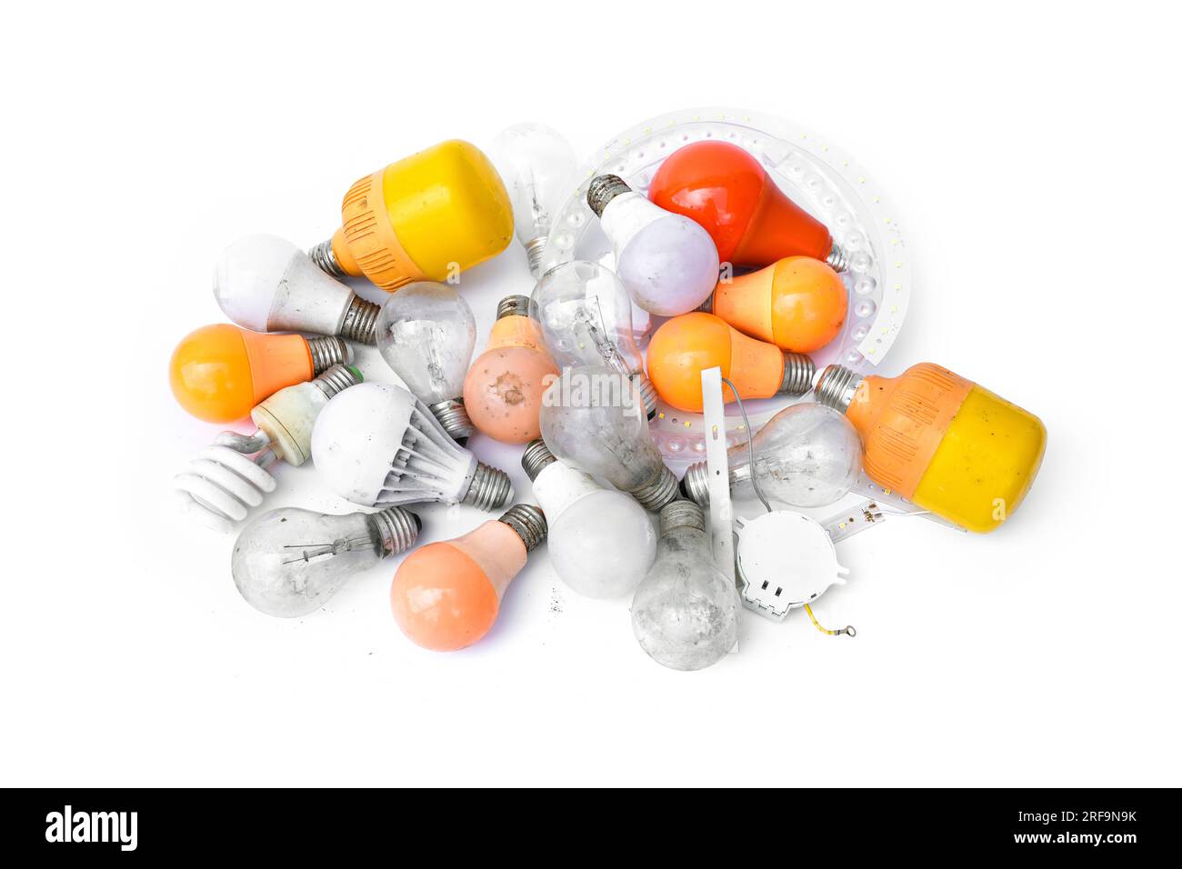 Pile of garbage Used and disposed of light incandescent bulb and energy saving lamps (LED) expired from use isolated on white background. Stock Photo