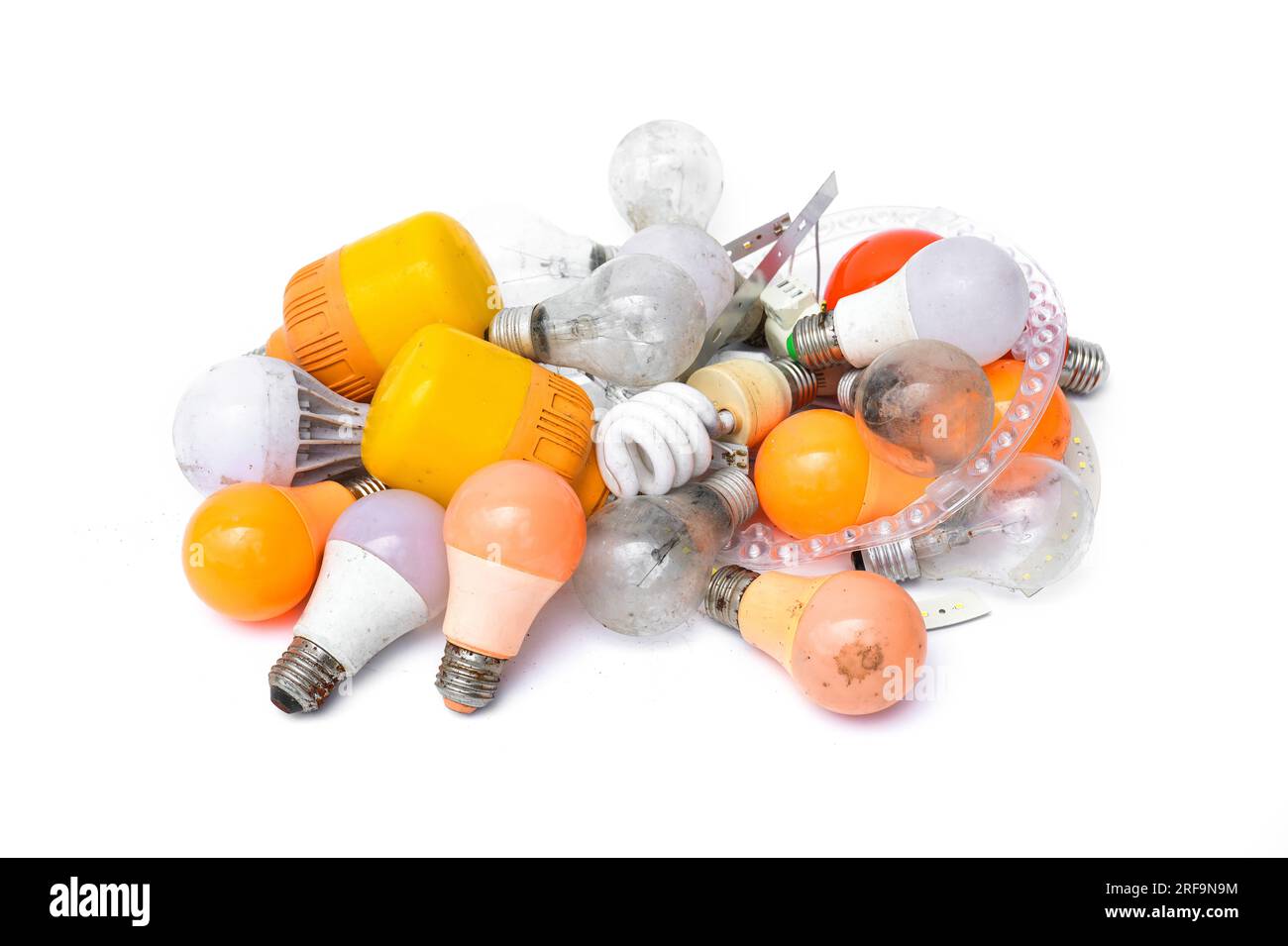 Pile of garbage Used and disposed of light incandescent bulb and energy saving lamps (LED) expired from use isolated on white background. Stock Photo