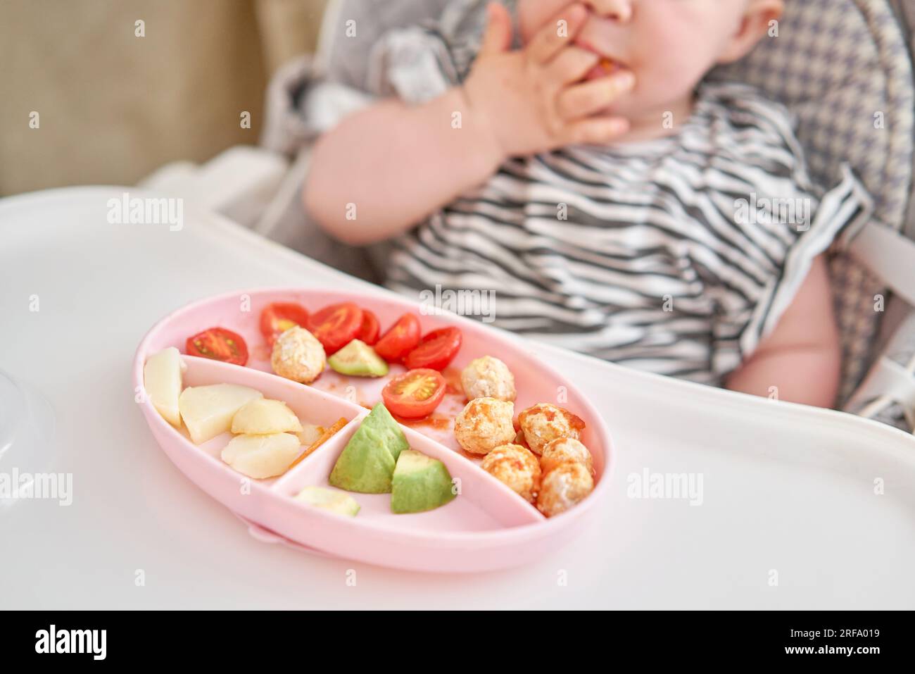 baby girl eating meat Cute child eats healthy food vegetables and meatballs from dietary meat  steamed,. Portraits of a cute 10 months old baby girl. The baby sitting in  a Stock Photo - Alamy