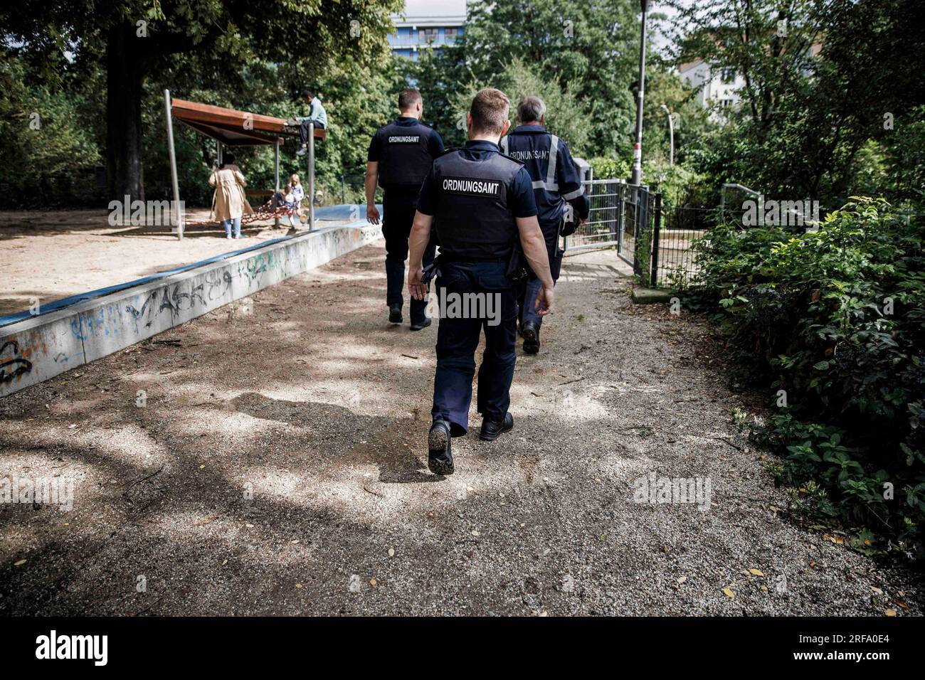 Berlin, Germany. 01st Aug, 2023. Employees of the public order office patrol a playground in Weinbergspark. The inspections by the public order office are concerned with violations of the Green Spaces Act and violations of the leash requirement for dogs. Credit: Carsten Koall/dpa/Alamy Live News Stock Photo