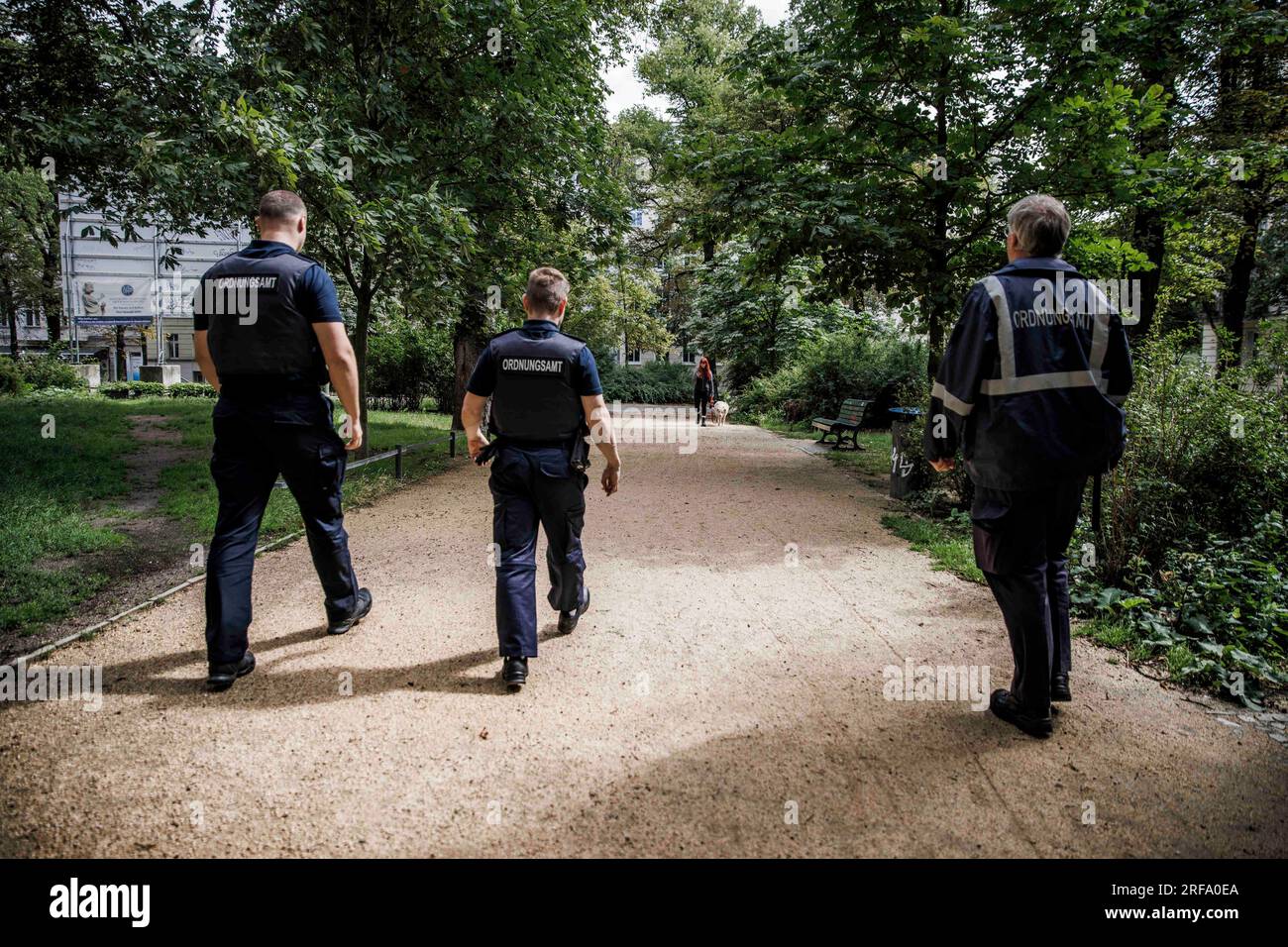 Berlin, Germany. 01st Aug, 2023. Employees of the public order office patrol Zionskirchplatz. The inspections by the public order office are concerned with violations of the Green Spaces Act and violations of the leash requirement for dogs. Credit: Carsten Koall/dpa/Alamy Live News Stock Photo