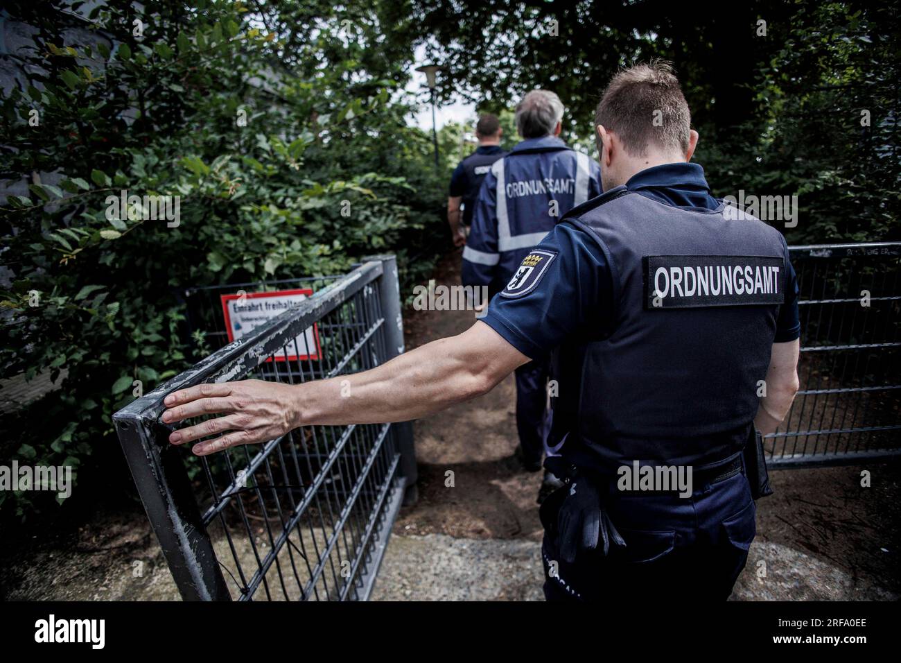 Berlin, Germany. 01st Aug, 2023. Employees of the public order office go on patrol in a playground in Weinbergspark. The inspections by the public order office focus on violations of the Green Spaces Act and violations of the leash requirement for dogs. Credit: Carsten Koall/dpa/Alamy Live News Stock Photo