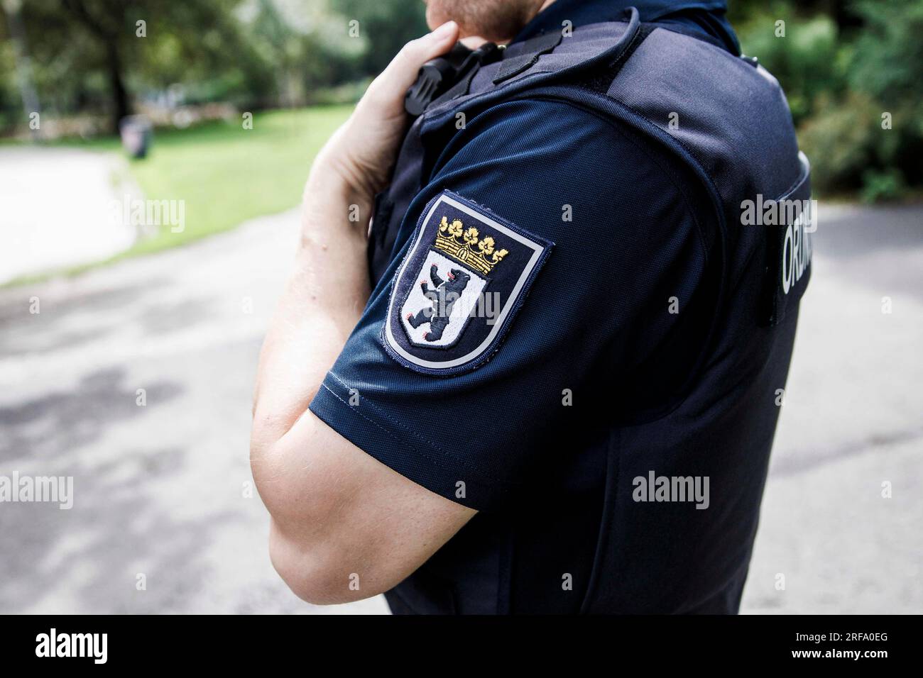 Berlin, Germany. 01st Aug, 2023. An employee of the public order office walks through Weinbergspark during a patrol. The inspections by the public order office focus on violations of the Green Spaces Act and violations of the leash requirement for dogs. Credit: Carsten Koall/dpa/Alamy Live News Stock Photo