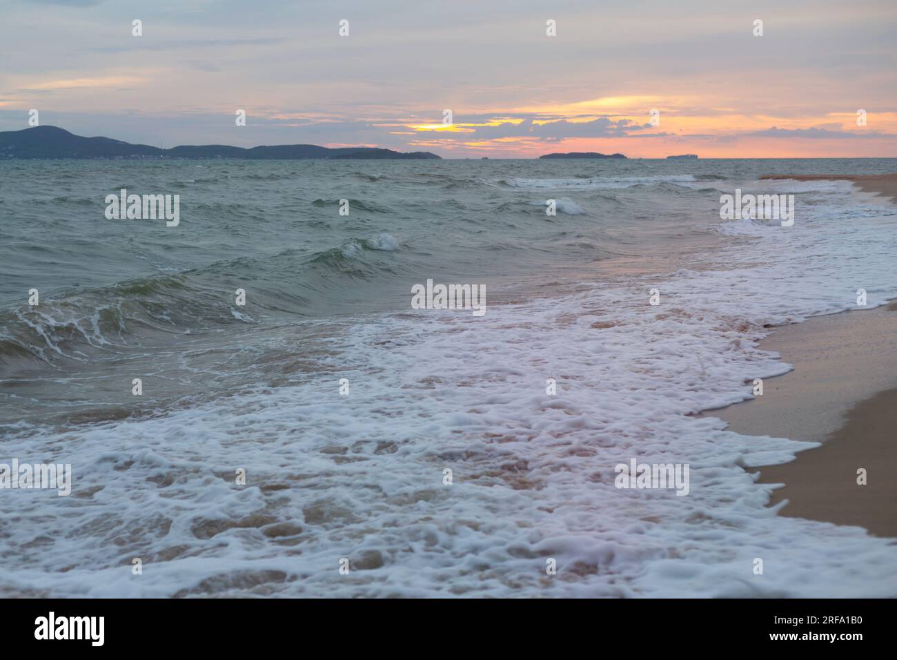 Raging Sea with Sunset Sky Background Stock Photo - Alamy
