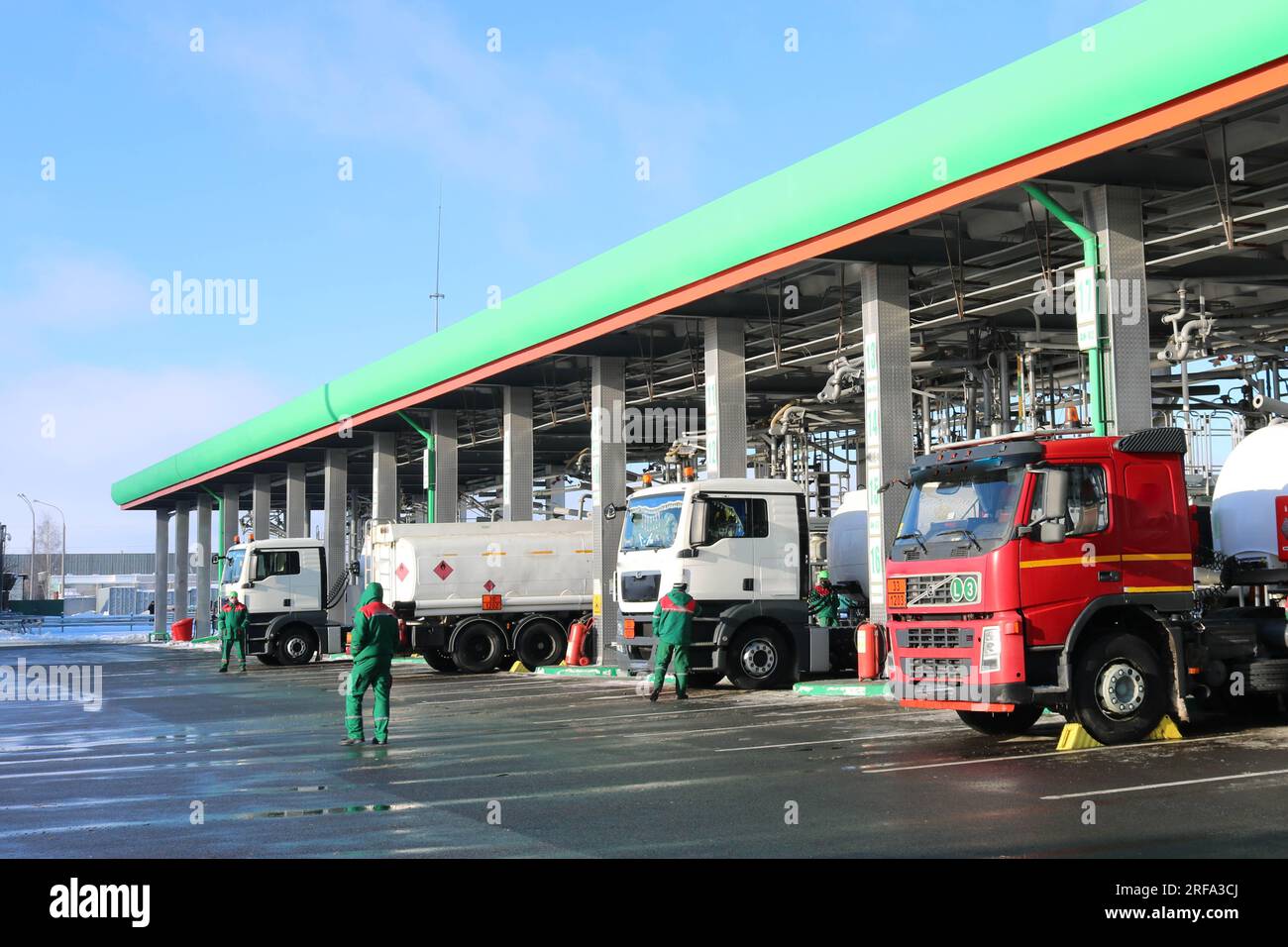 Large green industrial gas station for refueling vehicles, trucks and tanks with fuel, gasoline and diesel in the winter. Stock Photo