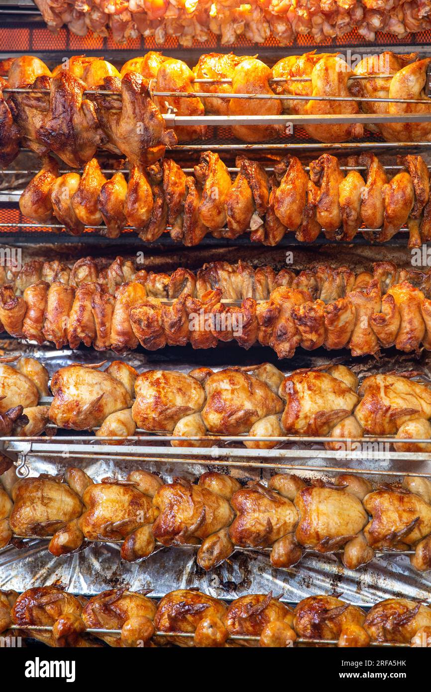 Rotisserie chicken on a rack roasting Stock Photo Alamy