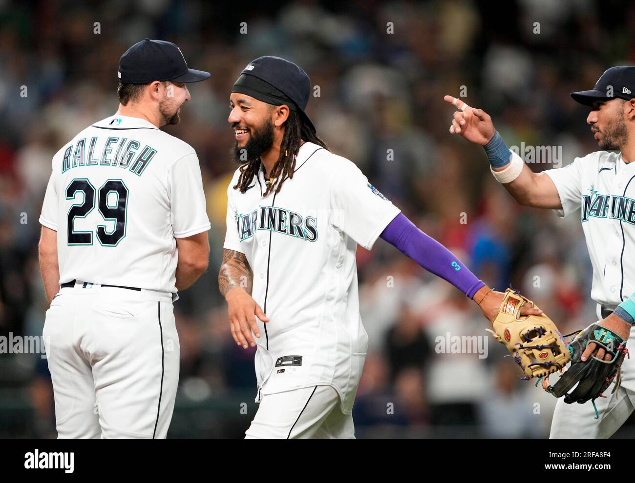 Seattle Mariners' Cal Raleigh (29) greets J.P. Crawford as they ...