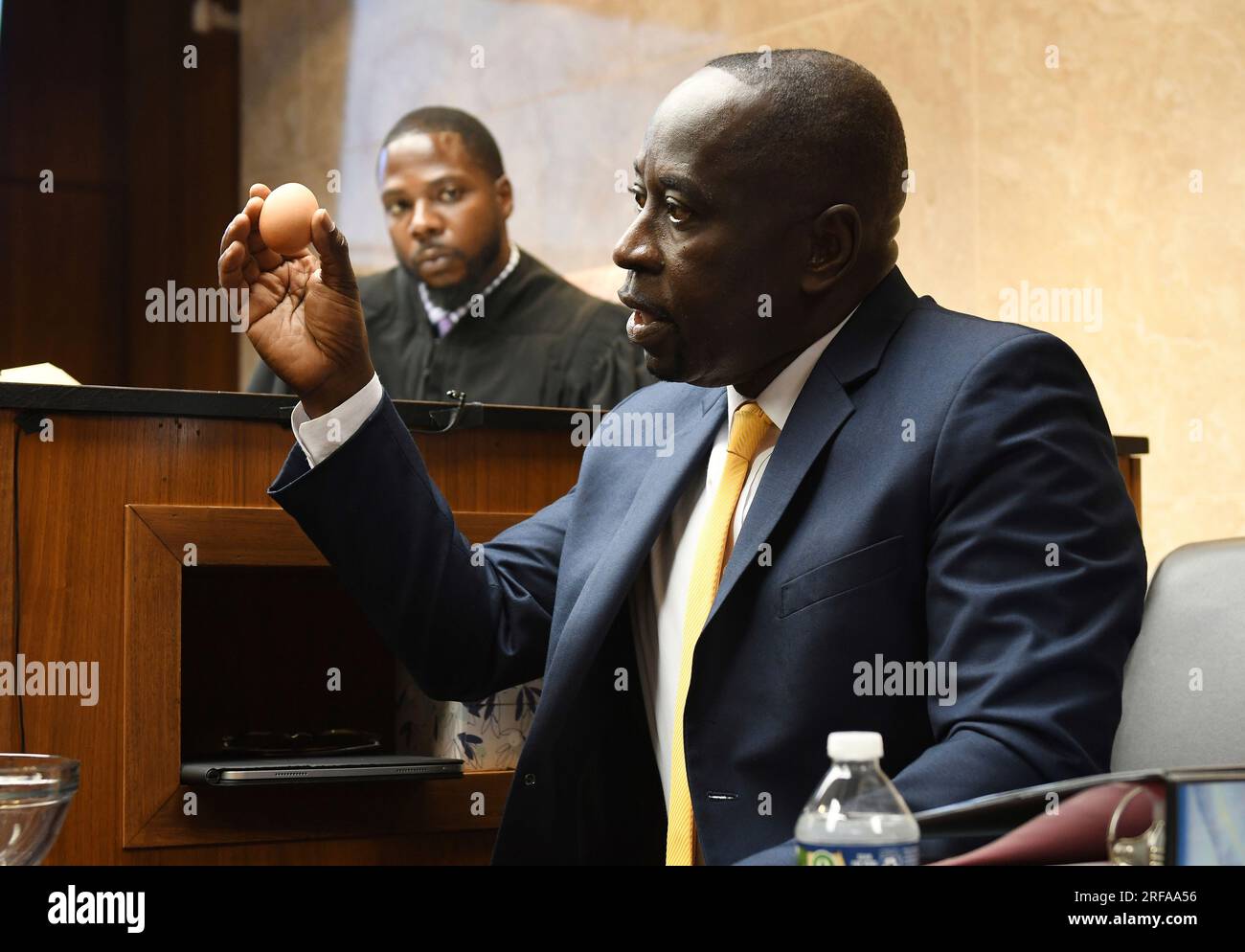 Dr. Colin King, uses an egg to demonstrate the softness of brain tissue in  Ethan Crumbley's brain during testimony in Ethan Crumbley's hearing at  Oakland County Circuit Court, Tuesday, Aug. 1, 2023