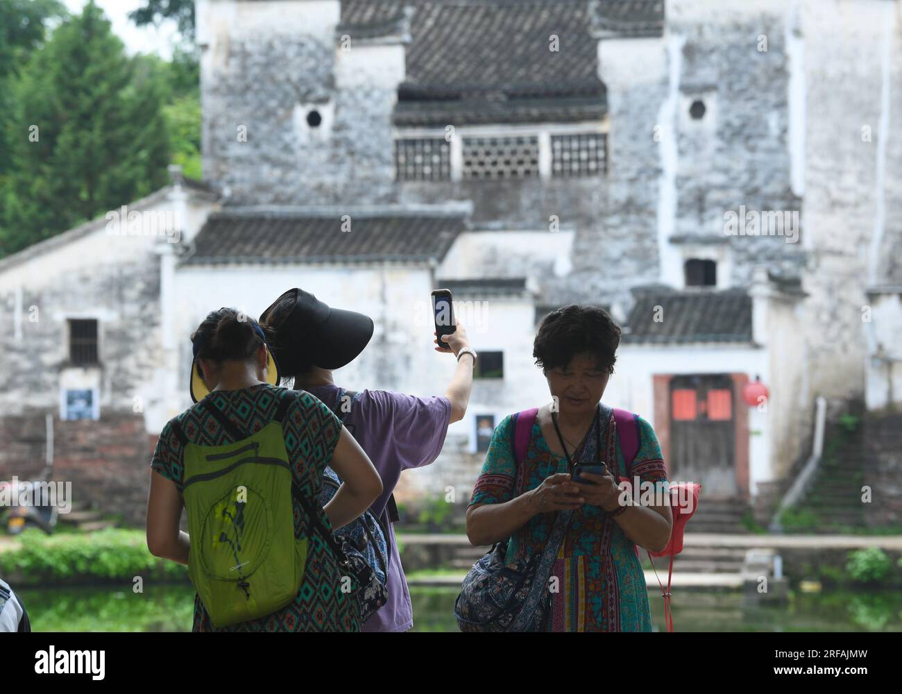 Jinhua, China's Zhejiang Province. 1st Aug, 2023. Tourists visit the Zhuge Village of Lanxi City, east China's Zhejiang Province, Aug. 1, 2023. The Zhuge Village, a historic gem with over 300 ancient buildings dating back to Ming and Qing dynasties (1368-1911), is home to descendents of Zhuge Liang, a renowned military strategist in the Three Kingdom Period (220-280). The village has made concerted efforts to preserve the ancient heritages and develop tourism, receiving over 500,000 visitors annually. Credit: Weng Xinyang/Xinhua/Alamy Live News Stock Photo