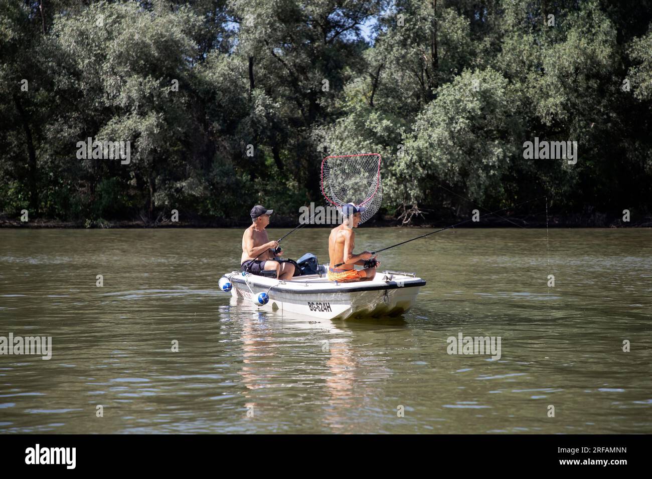 Two men fishing in a boat hi-res stock photography and images - Alamy