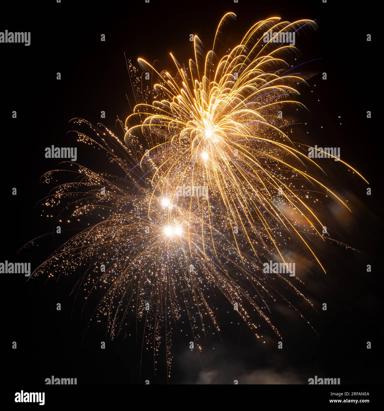 A firework display against a dark night sky Stock Photo