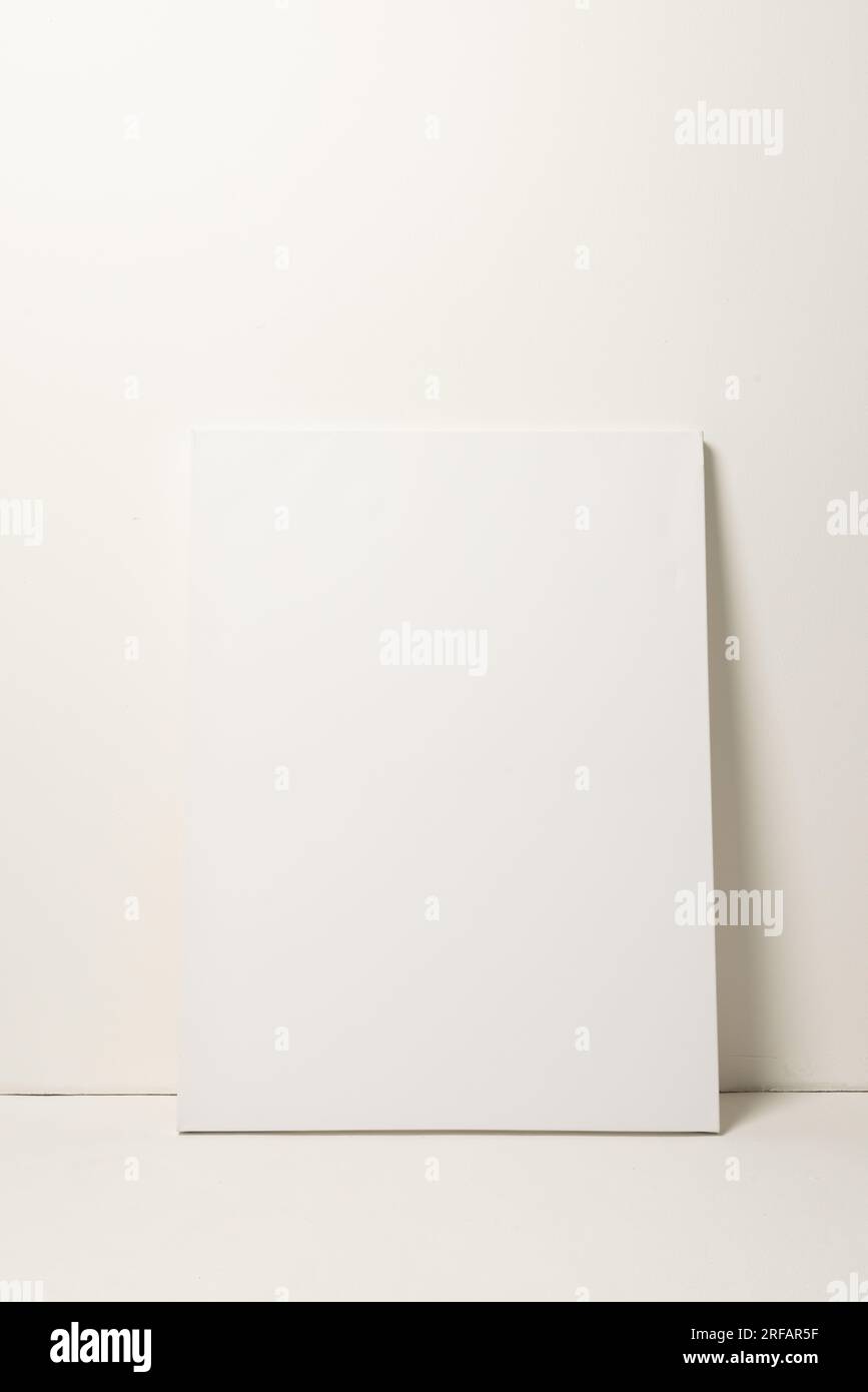 White canvas and copy space leaning against white wall background Stock Photo