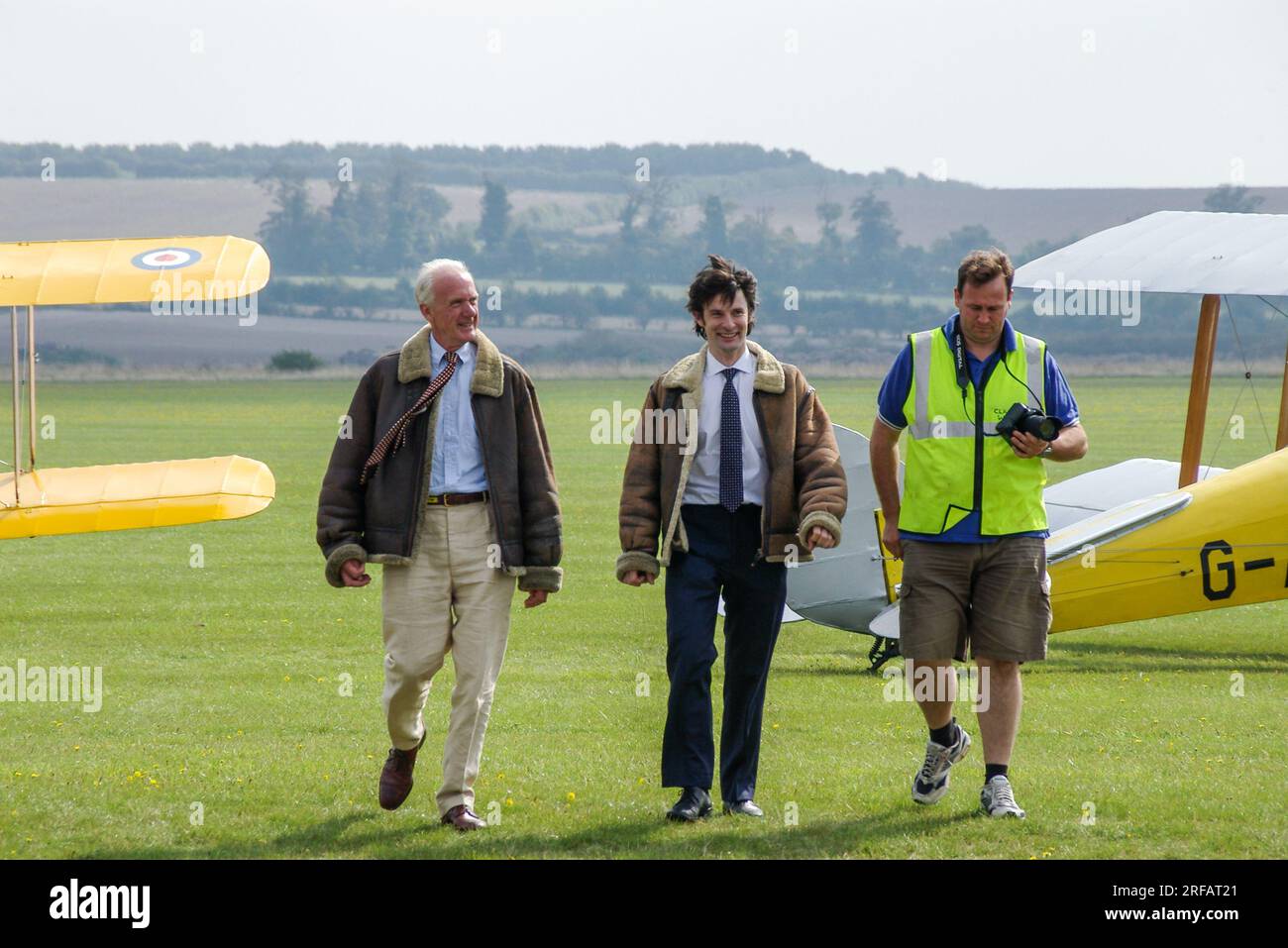 Actor Tom Ward at Duxford, Cambridgeshire, UK, walking back in after a flight in a Classic Wings Tiger Moth biplane. BBC Silent Witness TV star Stock Photo