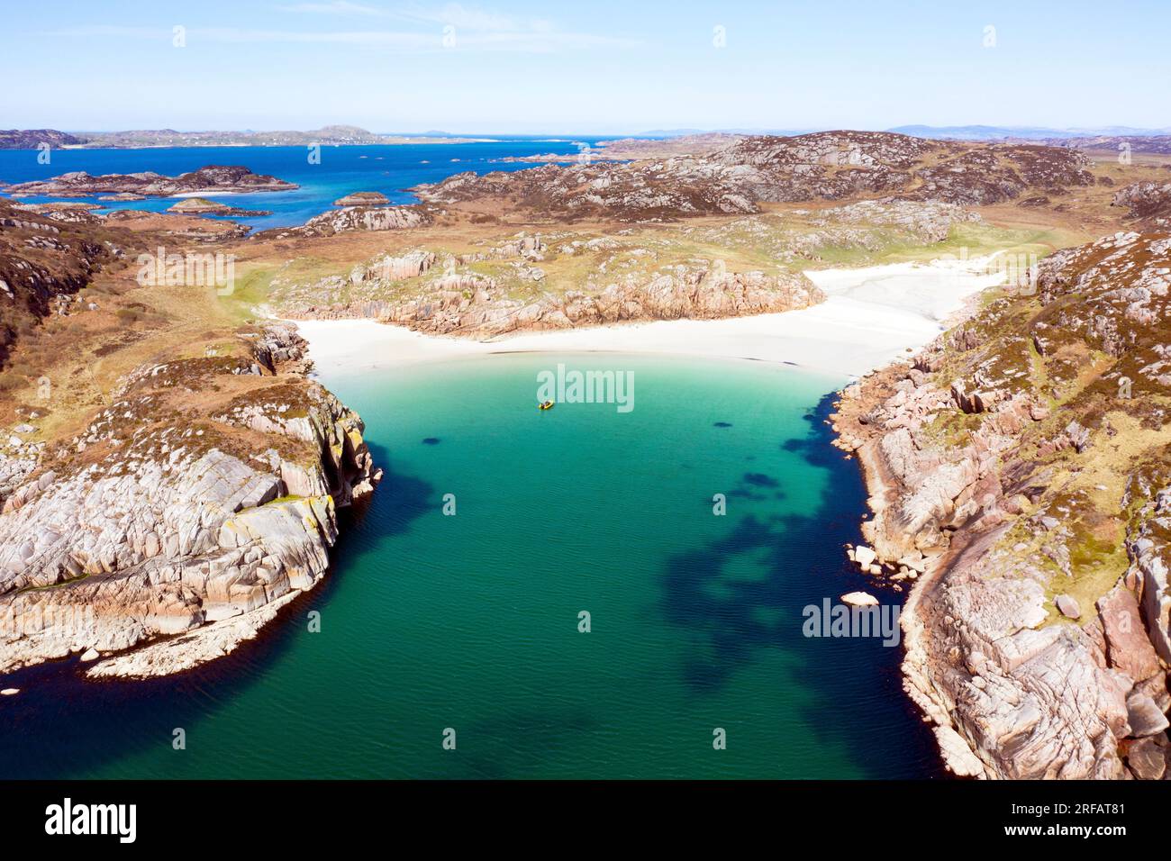 Aerial view from a drone of sandy beaches of Balfour's Bay on Erraid, Inner Hebrides of Scotland with the Isle of Iona in the distance top left Stock Photo