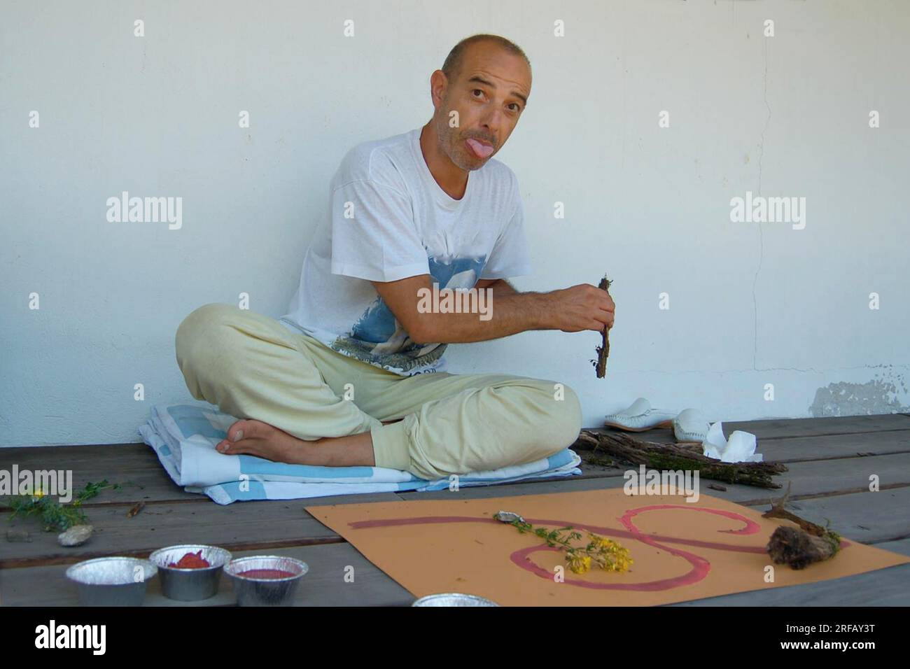 Middle-aged man practices yoga at the beach Stock Photo - Alamy