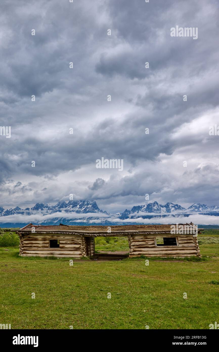 J.P. Cunningham Cabin, Cunningham Cabin Historic Site and Grand Teton Range under heavy clouds, Grand Teton National Park, Wyoming, United States of A Stock Photo