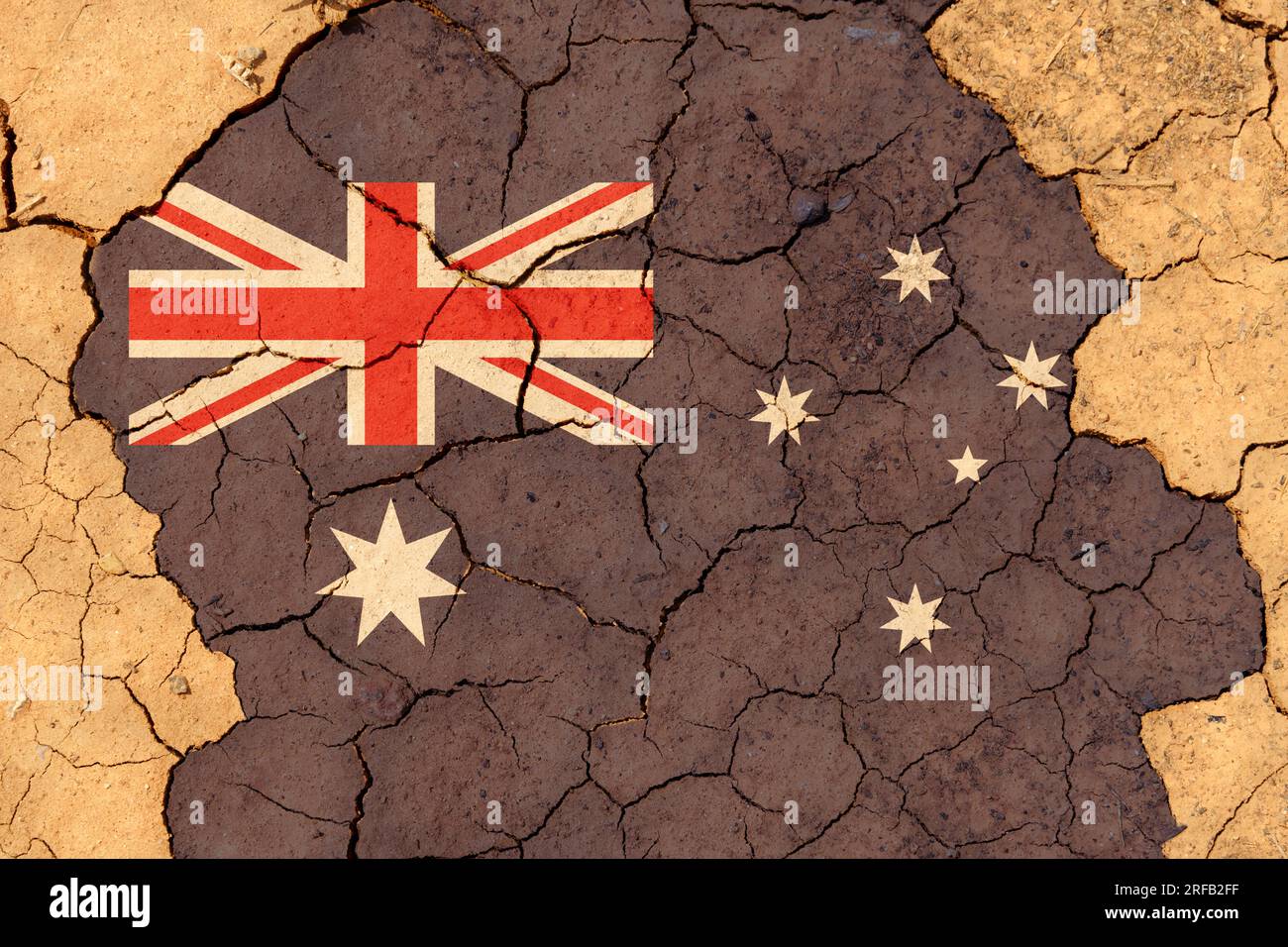 Ecological concept. Drought. On dry, cracked ground, the image of the flag of Australia. Stock Photo