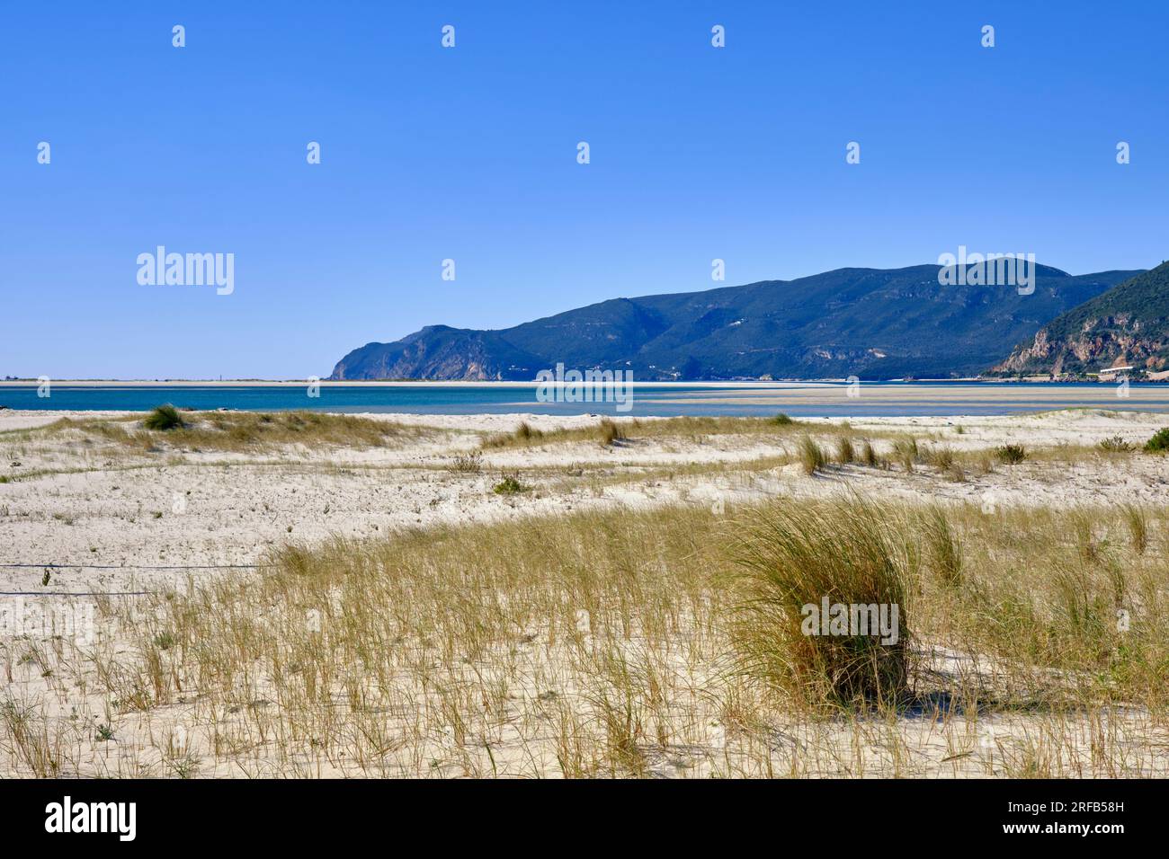 The beach at Troia peninsula and the Arrabida Nature Park mountain range. Alentejo, Portugal Stock Photo