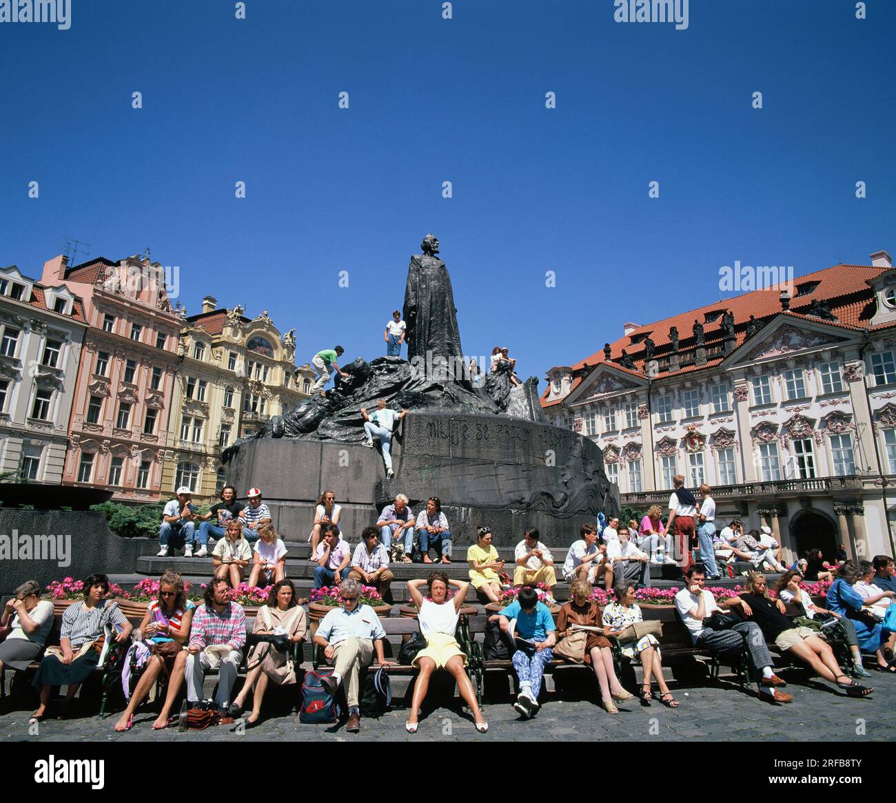 Czech Republic. Prague city. Tourists sitting around the Jan Hus monument. Stock Photo
