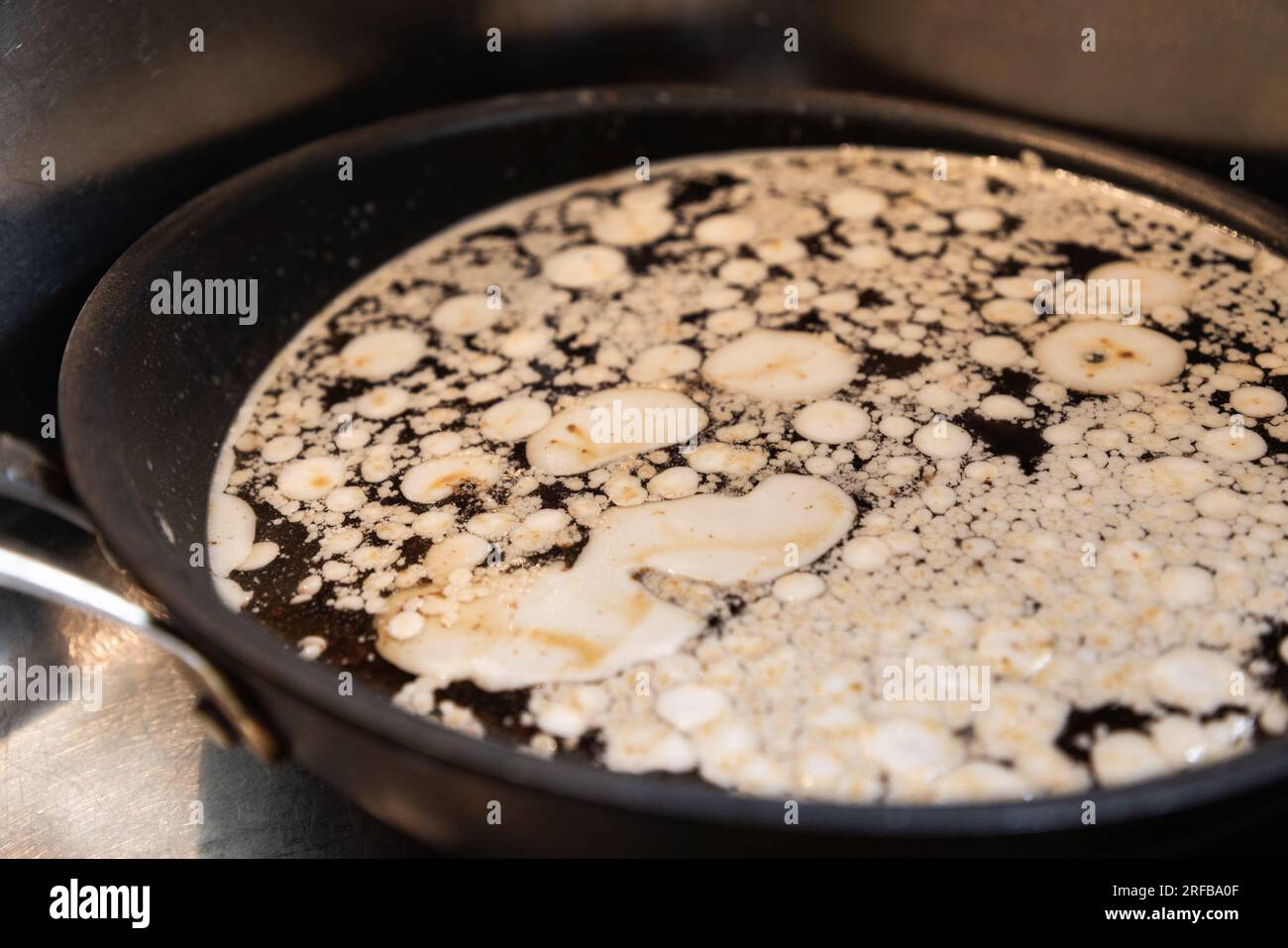 Cooking grease in a frying pan in the sink, after someone fried bacon