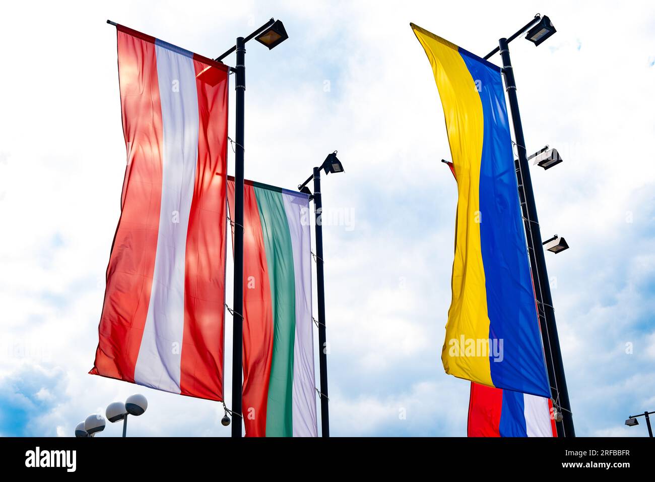Flags of Austria, Ukraine, Bulgaria against the sky Stock Photo